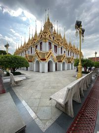 View of temple building against cloudy sky