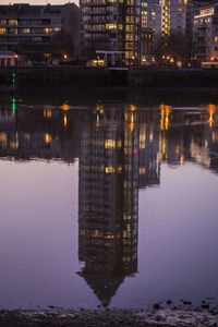 Reflection of illuminated buildings in river at night