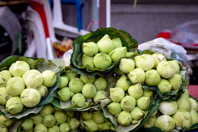 Green fruits for sale at market stall