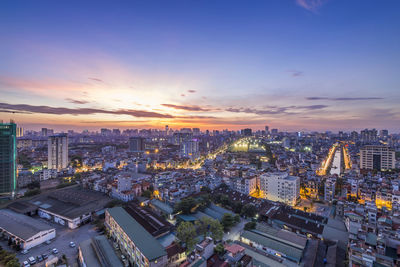 High angle view of city buildings against sky during sunset