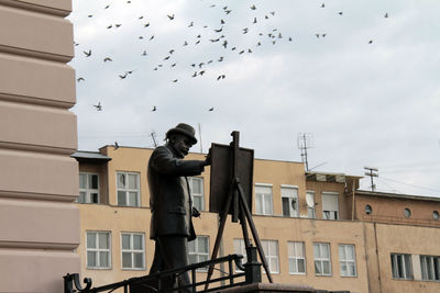 Low angle view of woman flying against sky