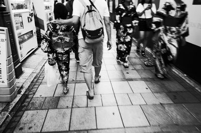 Rear view of people walking on street