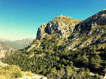 Scenic view of mountains against clear blue sky