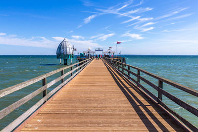 Pier over sea against sky