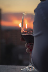 Midsection of man holding wineglass