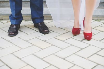 Low section of bride and bridegroom standing