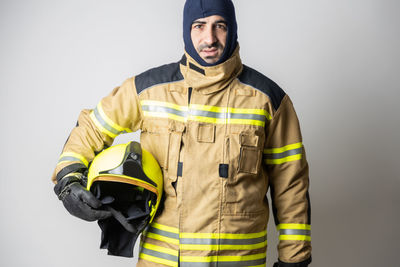 Portrait of man standing against white background