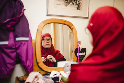 Woman looking at mirror