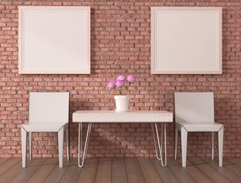 Potted plant on table against wall at home