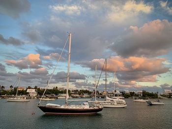 Boats in sea against sky during sunset