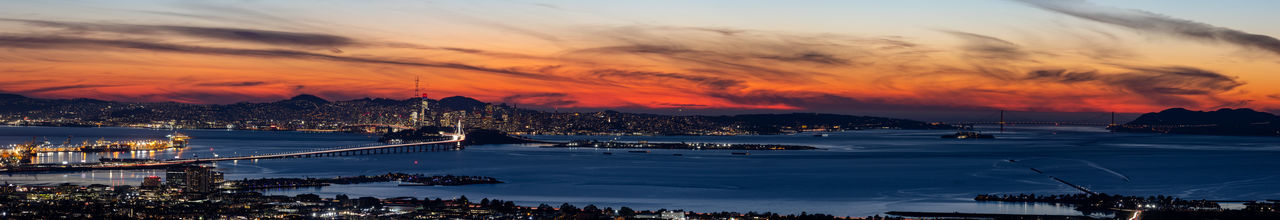 Sunset view of the bay bridge leading into the san francisco skyline