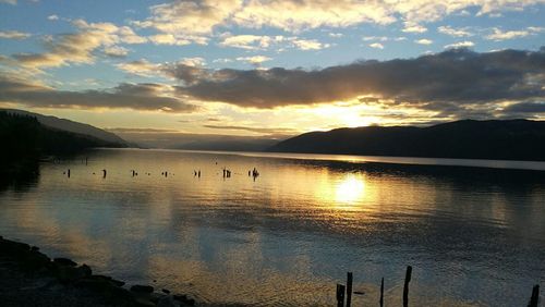 Scenic view of lake against sky during sunset