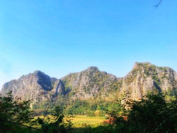 Scenic view of mountains against clear blue sky