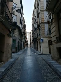 Road amidst buildings in city