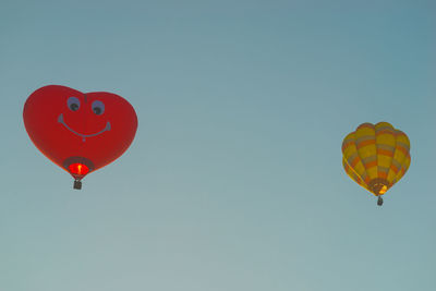Low angle view of hot air balloon against clear blue sky