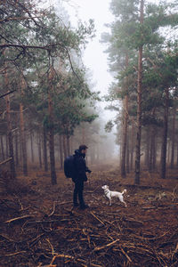 Woman with dog in forest