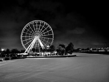 Illuminated ferris wheel at night