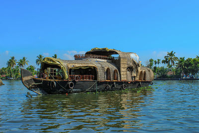 Built structure in water against clear blue sky