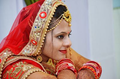 Close-up of bride against wall