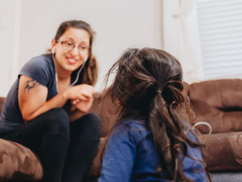 Women sitting on sofa at home