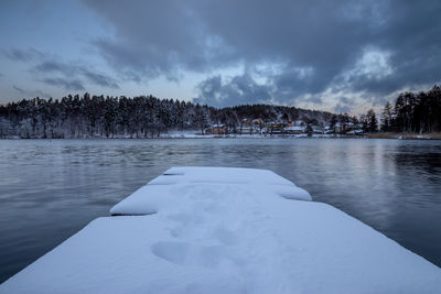 Frozen lake against sky during winter