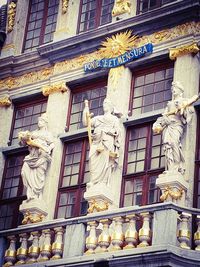 Low angle view of statue against building in city