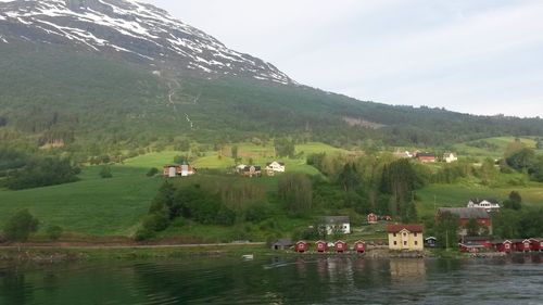 Scenic view of river and mountains against sky