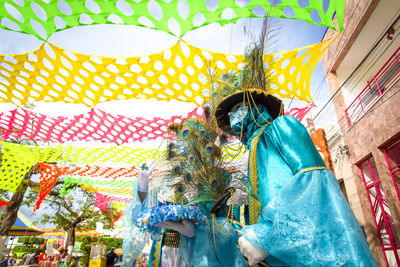 Two people wearing carnival mask