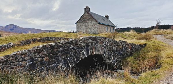 Old building on field against sky