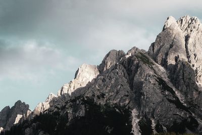 Low angle view of rocky mountains against sky