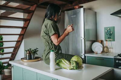 Midsection of woman holding food at home