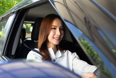 Portrait of smiling woman in car