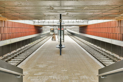 Rear view of man walking on escalator