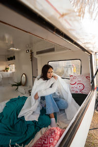 Rear view of woman sitting in car