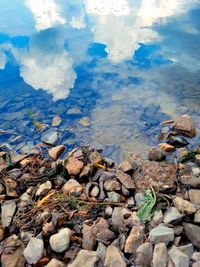 Close-up of pebbles in lake