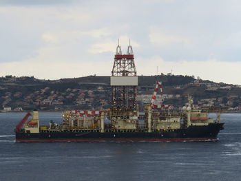 Commercial dock by sea against sky