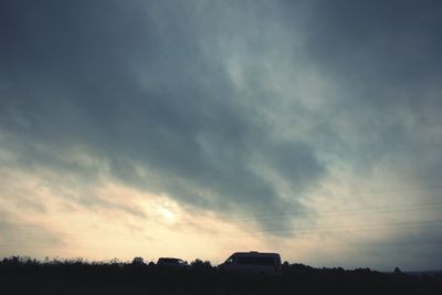 Silhouette landscape against sky at sunset