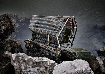 High angle view of abandoned shopping cart in lake