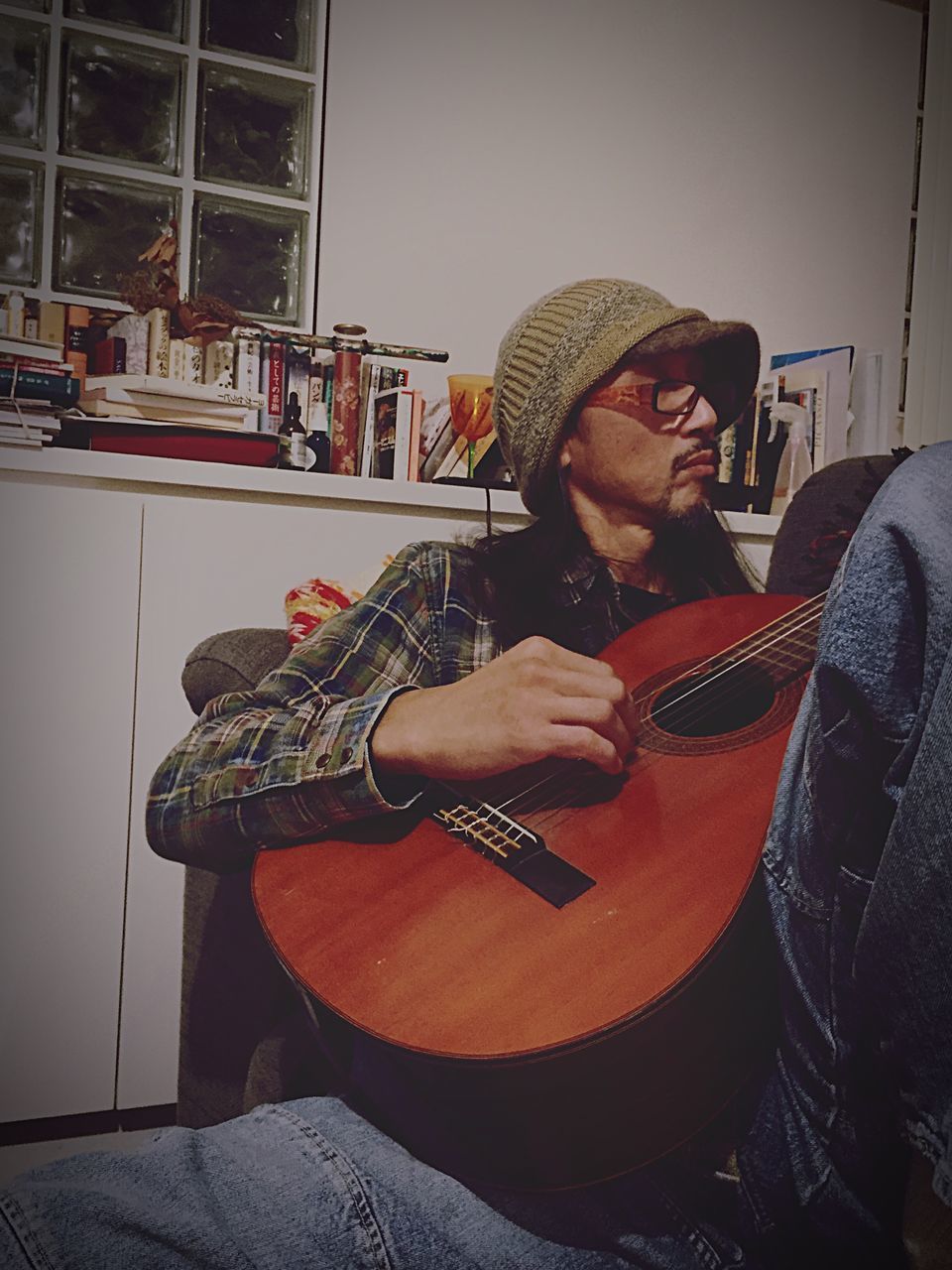 hat, guitar, music, sitting, lifestyles, plucking an instrument, musical instrument, beard, playing, men, home interior, string instrument, only men, one person, adults only, indoors, real people, adult, one man only, musician, people, day