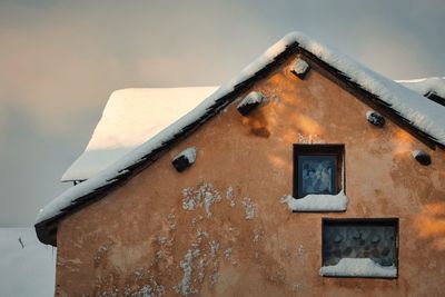 House in  snow landscape in wintertime with trees in aveyron, france