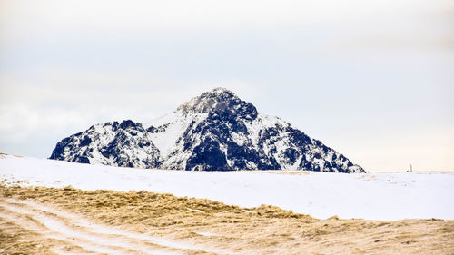 Scenic view of snowcapped mountains against sky