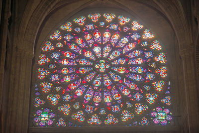 Low angle view of stained glass window in building