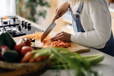 Midsection of man preparing food at home