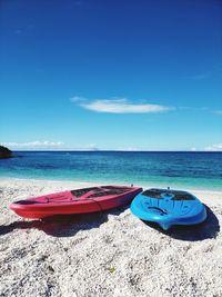 Paddle boards are ready for that adventure on beach against blue sky