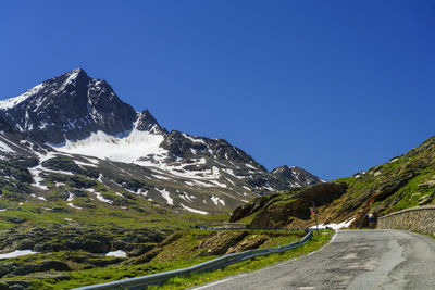 Scenic view of snowcapped mountains against clear blue sky