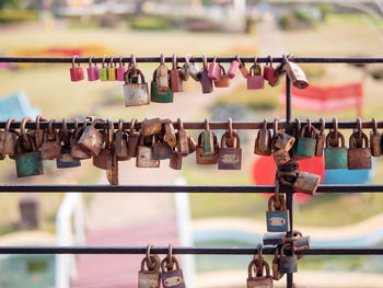 Padlocks hanging on railing