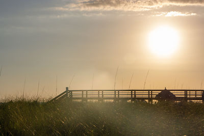 Scenic view of field against sky during sunset