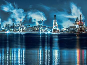 Illuminated commercial dock against sky at night