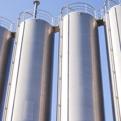 Low angle view of industry against clear sky