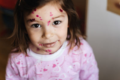 Close-up portrait of cute girl at home